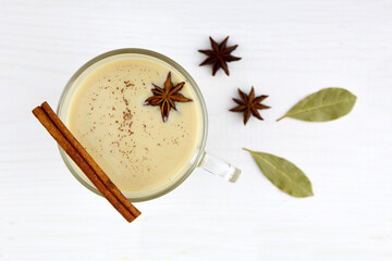 A cup of masala tea. Traditional Indian tea drink with milk and spices. Top view. Close-up.