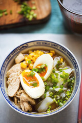 Japanese ramen noodle soup with chicken, corn, scallions, rice noodles
