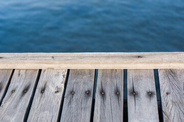 Wooden floor and sea blur background