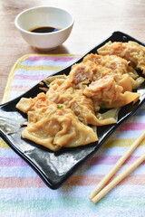 boiled dumpling or gyoza stuffed mashed pork and shrimp with vegetable topping fried chop garlic on plate dipping sweet soybean sauce