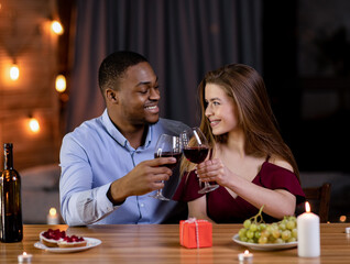 Romantic Dinner. Happy Multiracial Couple Celebrating Valentine's Day Together, Drinking Red Wine