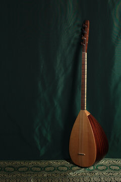 traditional Turkish national musical instrument baglama saz on a dark green background. a magnificent century. The concept of Islam