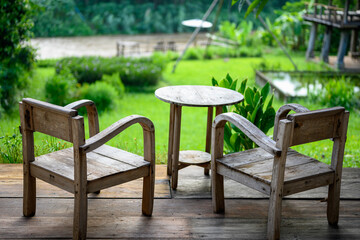 Wooden chairs with river and park background. 
