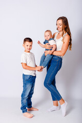 Happy mother and two children on white background