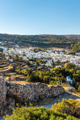 view of  a part of the vyzantine road in foreground and traditional Cycladitic  architecture in the...