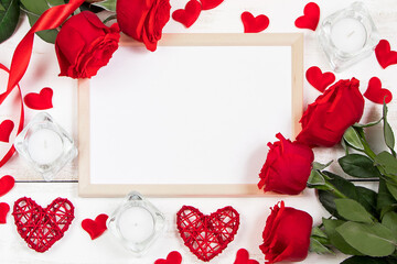 Red roses and hearts on a white wooden background. Valentine's day, place for text.