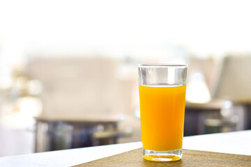 Fresh orange juice in a glass on the table