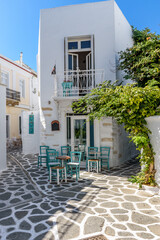 Traditional Cycladitic alley with narrow street, whitewashed houses and facades  in parikia, Paros island, Greece.