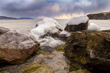 Snow-covered rocks in the sea
