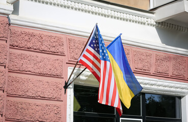 Flags of Ukraine and USA on building facade