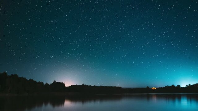 Lyepyel District, Vitebsk Province, Belarus. Real Colorful Night Stars Above Lepel Lake. Natural Starry Sky Background Backdrop Landscape. Time lapse.
