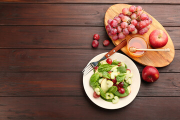 Fototapeta na wymiar Delicious fresh celery salad served on wooden table, flat lay. Space for text