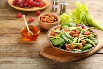 Delicious fresh celery salad on wooden table. Space for text