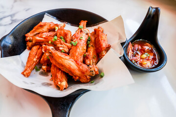 Close up of Thai Salt Fried Chicken Wing with Chilli Sause