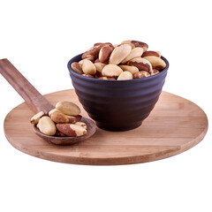 Brazil nuts in brown bowl and spoon on wood board isolated on white background, copy space.