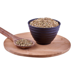 Fennel seeds in brown bowl on wood board isolated on white background, copy space.