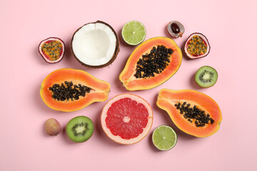 Fresh ripe papaya and other fruits on pink background, flat lay