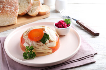 Delicious chicken aspic served on white wooden table