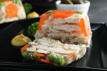Delicious chicken aspic with vegetables on plate, closeup
