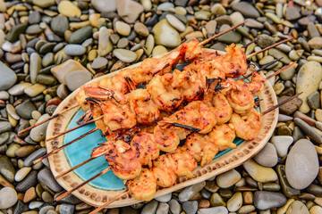 langoustine tails on skewers cooked on charcoal