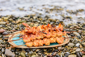 langoustine tails on skewers cooked on charcoal