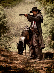 A senior cowboy standing with a gun to guard the safety of the camp in the western area