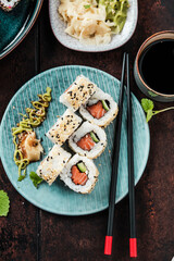 japanese sushi food. Maki ands rolls with tuna, salmon, shrimp, crab and avocado. Top view of assorted sushi. Rainbow sushi roll, uramaki, hosomaki and nigiri.