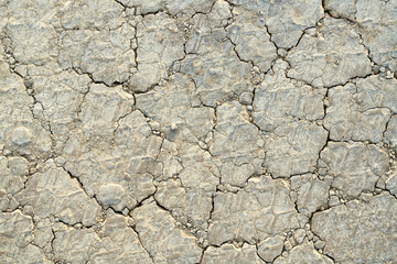 Dry soil background, land cracks surface texture.