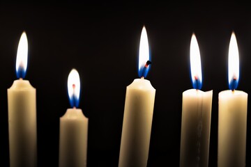 Candles glowing against dark background