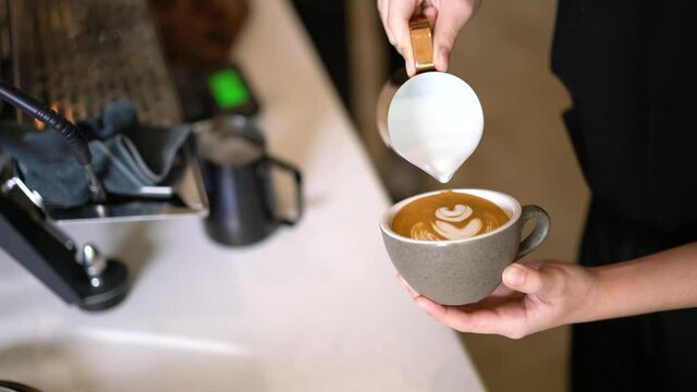 4k, Barista make latte art on hot coffee, Worker making pouring steamed milk with cappuccino
