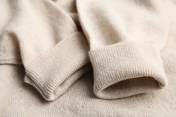 Warm cashmere sweater as background, closeup view