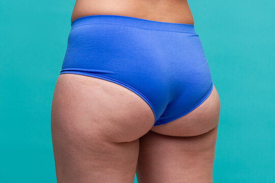 Fat hips and buttocks, obesity female body on blue background