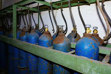 Old rusty bundle of blue gas cylinders