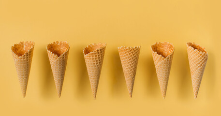 Ice cream cones levitate over yellow background