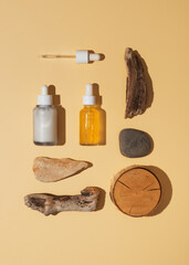 Natural cosmetic concept with serum and cream tube and bottles with natural materials