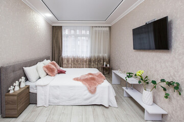 Interior photography, large bedroom with large bed, and TV in a modern style