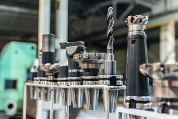 Accessories and tools for a CNC machine on a rack for equipment at a factory and enterprise.