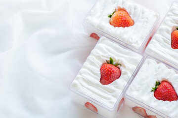strawberry shortcake in plastic box on with cloth background and copy space,
