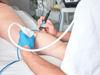 doctor treating a patient with percutaneous electrolysis, no faces shown