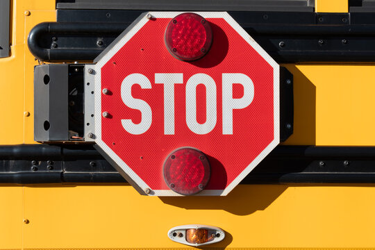 Stop sign on the side of a school bus