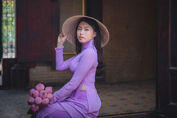 Young Vietnam woman wearing Ao Dai culture traditional at old temple at Ho Chi Minh in Vietnam,vintage style,travel and relaxing concept. - 408098576