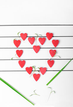 Heart arranged of small hearts on the musical staff. Conceptual photo representing love for music or Valentine's Day