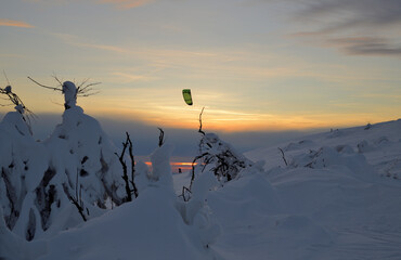 Naklejka na ściany i meble Ein Snow-Kiter im Sonnenuntergang im Winter