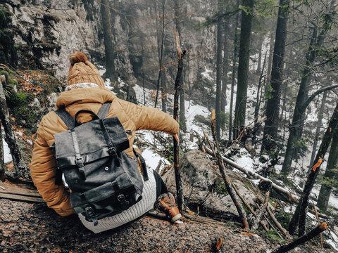 High Angle View Of A Caucasian Woman Dressed Appropriately For Winter Going Down The Hiking Trail