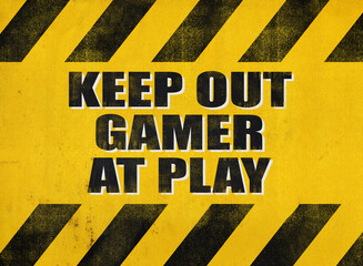 A funny text warning, Keep out, gamer at play, written over a yellow grunge background of diagonal stripes (a recognizable pattern designed to warn about a danger).

