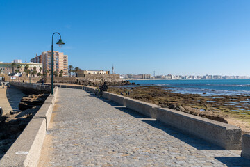 view of the town of Cadiz and the Paseo de Fernando Quinones walkway at La Caleta Beach