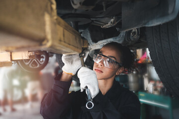 Female auto mechanic work in garage, car service technician woman check and repair customer car at automobile service center, inspecting car under body and suspension system, vehicle repair service sh - Powered by Adobe