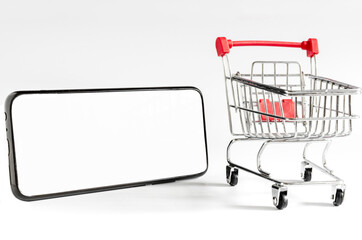 Red empty cart out of the store and smartphone with white screen on a light background, the concept of online trading