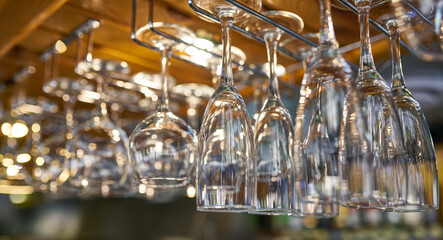 Fototapeta na wymiar glasses for wine above a bar rack