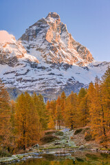 Blue Lake and the surroundings area during the fall and changing of the colors. Foliage, reflection and snowy peaks.